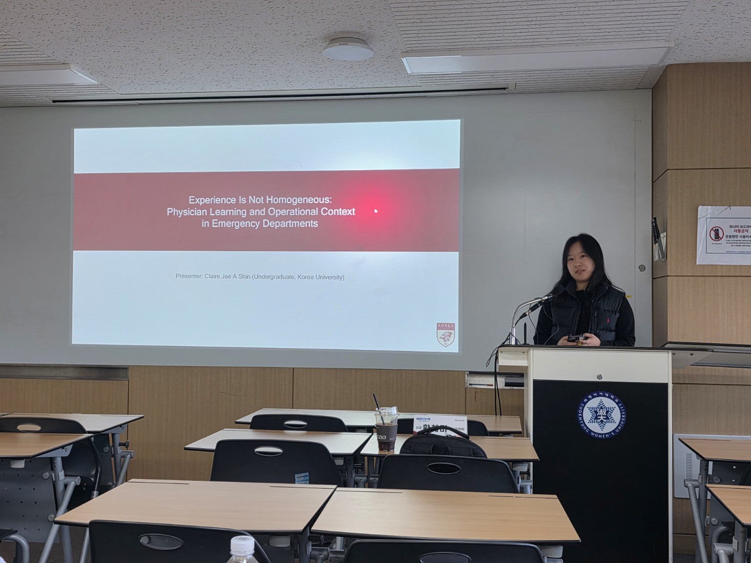 Claire Shin presenting a slide about physician learning in emergency departments.